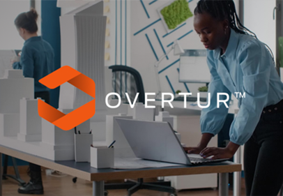 Promotional image featuring the logo for 'OVERTUR™' with a stylized orange hexagon. In the background, a focused woman is working at a standing desk in an office environment.