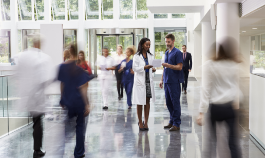 Medical professionals in busy corridor of healthcare building